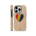A cozy phone case featuring a rainbow embroidered heart patch with visible stitching on a beige burlap canvas background, designed for iPhone, Samsung, and Pixel.